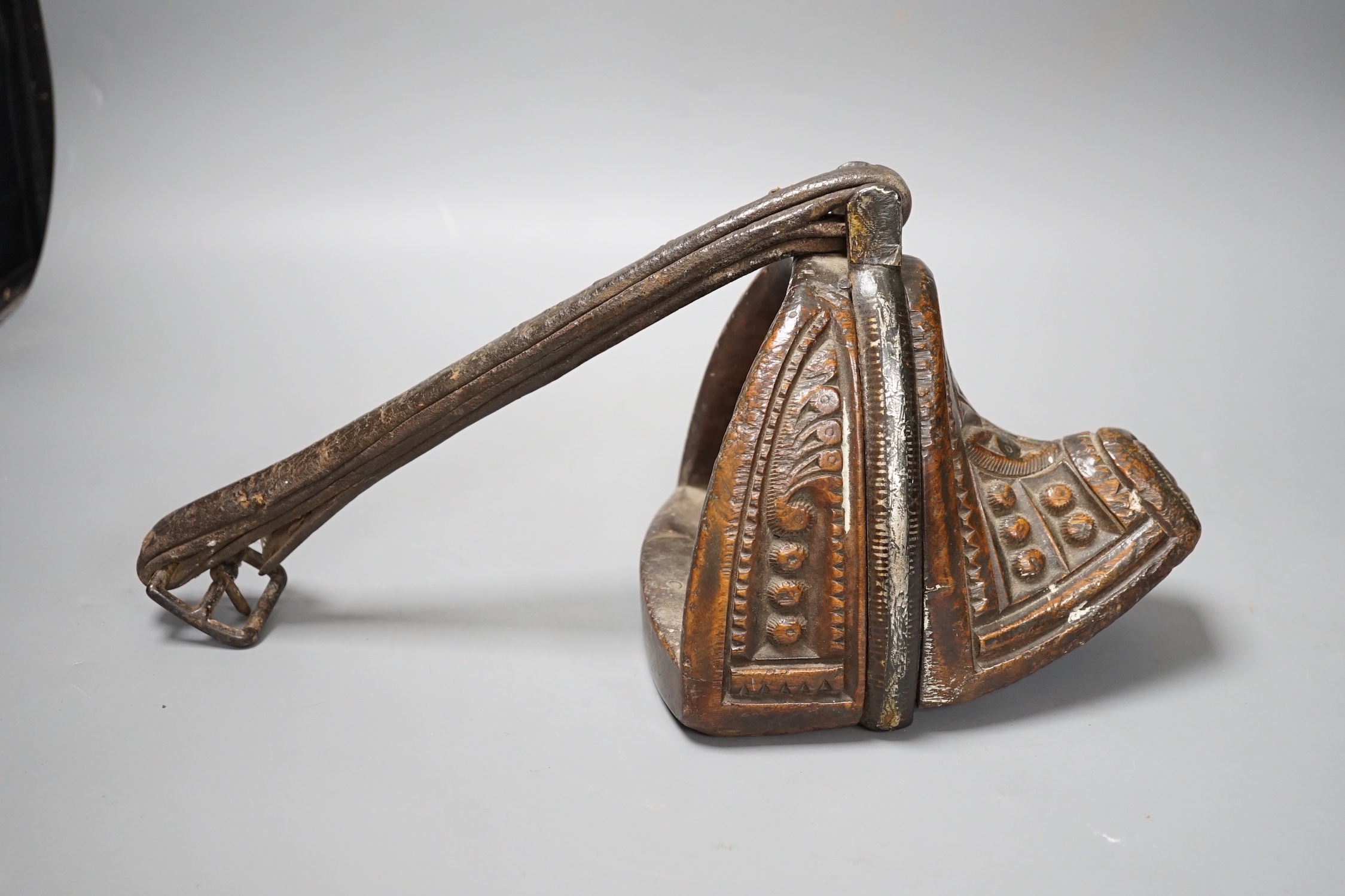 A 19th century Mongolian carved wood and bronze stirrup shoe